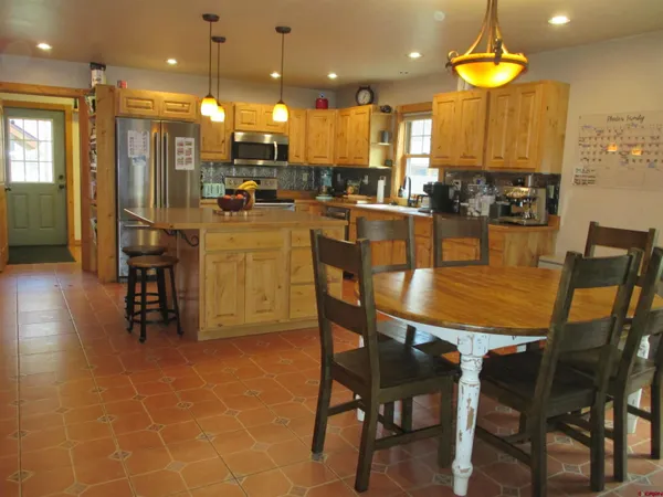 a large kitchen with a table and chairs