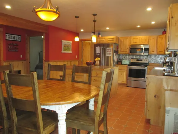 a kitchen with a table and chairs