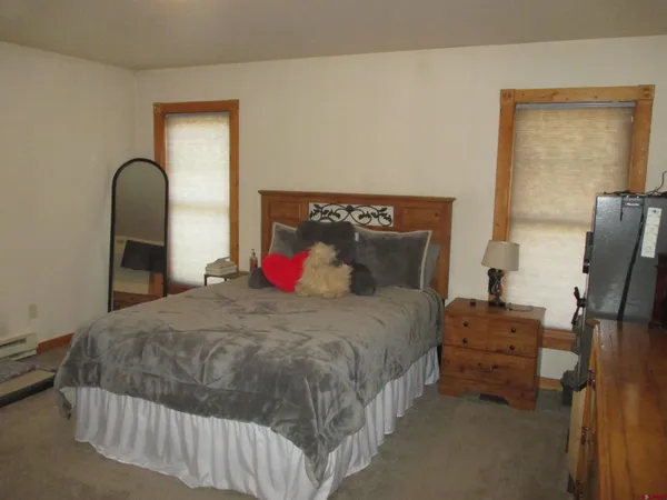 a bedroom with a bed and a potted plant