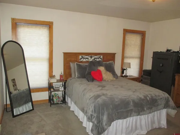a bedroom with a bed and a mirror