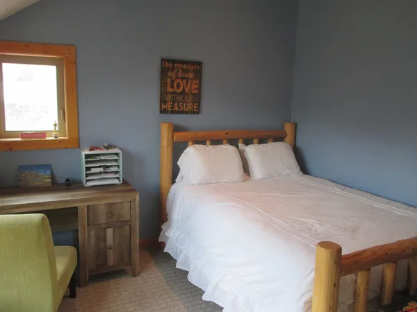 a bedroom with a bed and a window