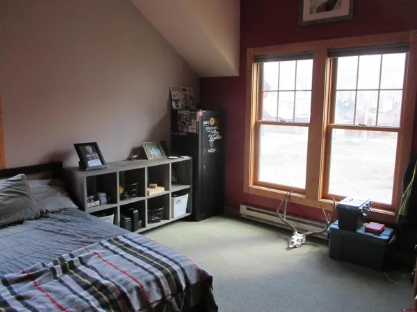 a bedroom with a bed closet and a window
