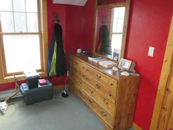 a spacious bedroom with a bed and a window