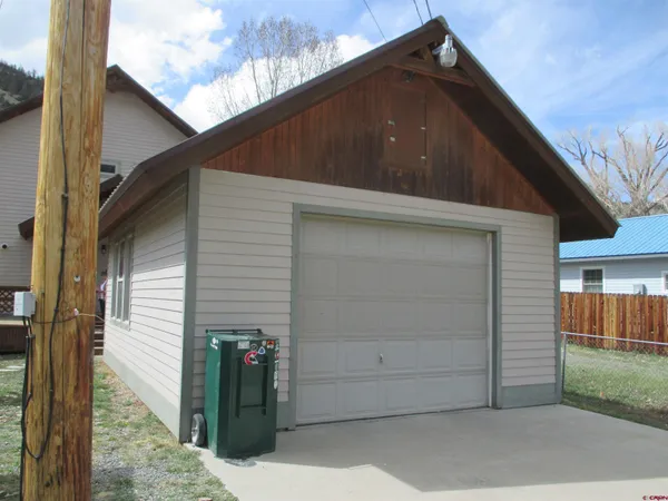 a side view of a house with a backyard