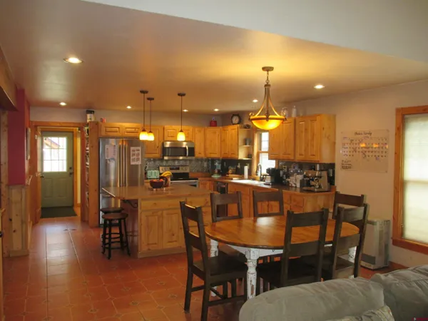 a dining area with a table chairs and a chandelier