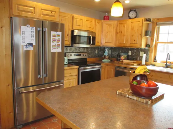 a kitchen with stainless steel appliances a refrigerator and a stove