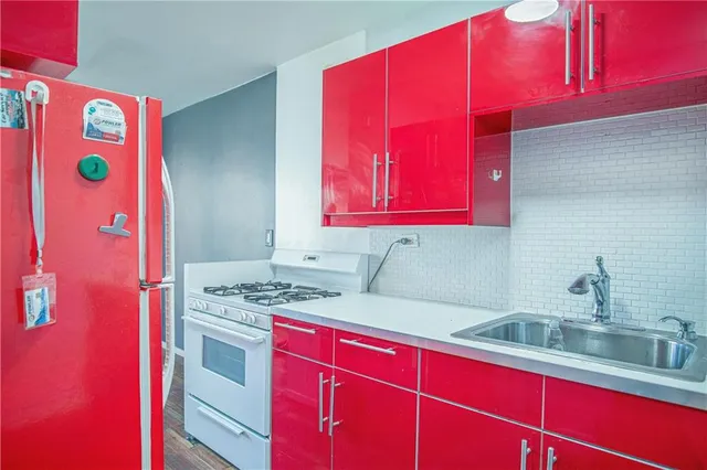 a kitchen with stainless steel appliances a sink and a microwave