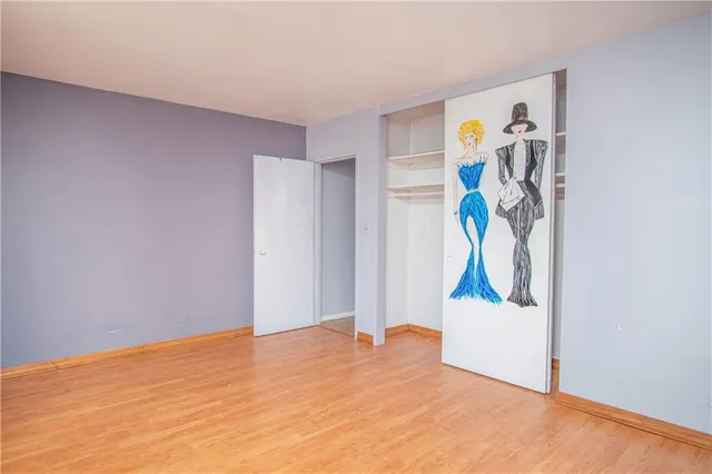 a view of empty room with ceiling fan and window
