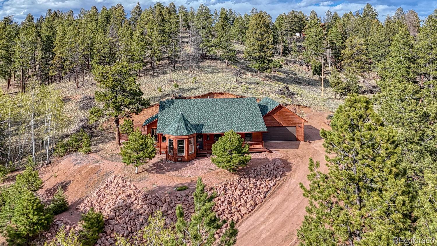 an aerial view of a house with a yard