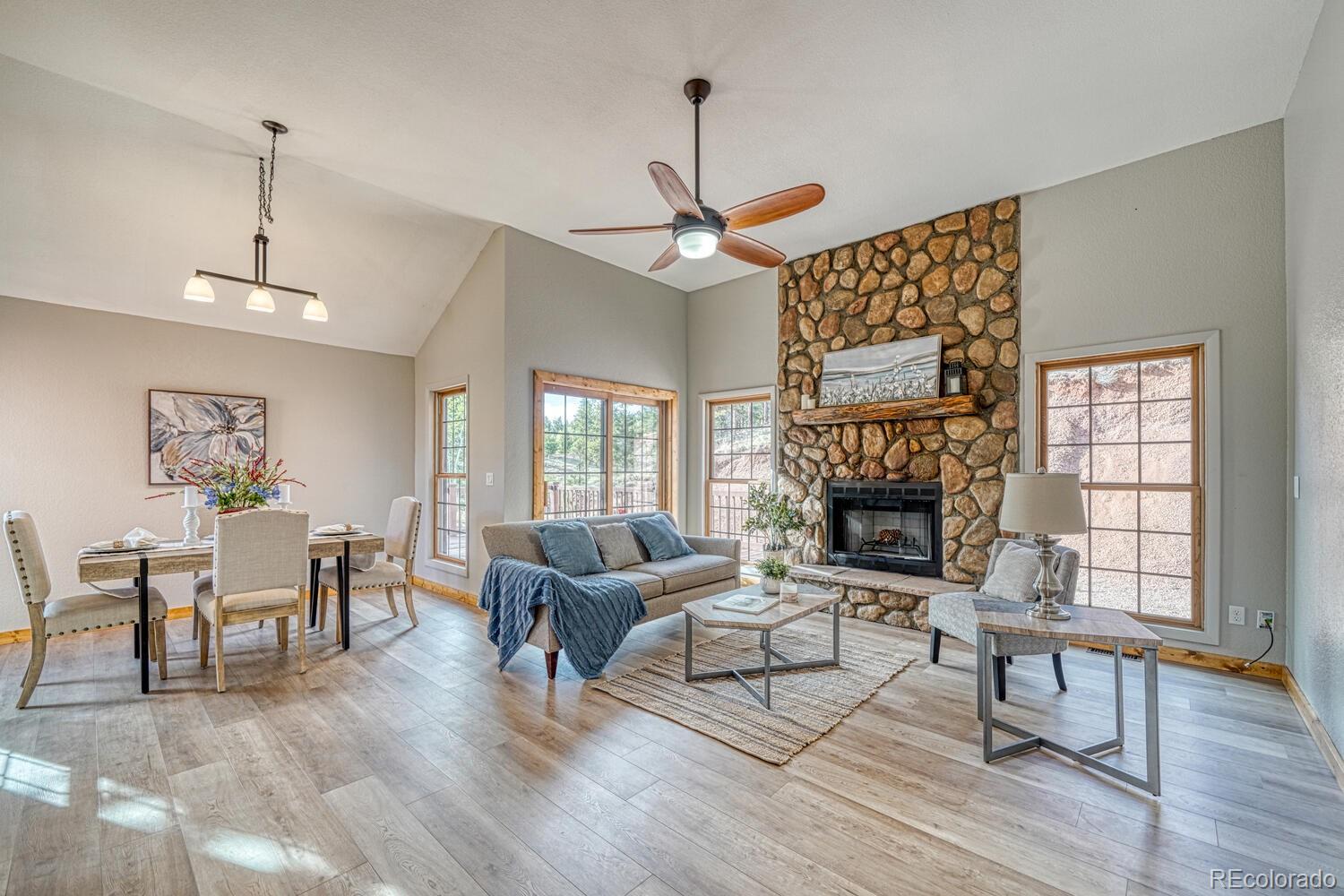 318 Southgate Road Florissant, CO 80816 - Photo 14 of 48 a living room with fireplace furniture and a wooden floor