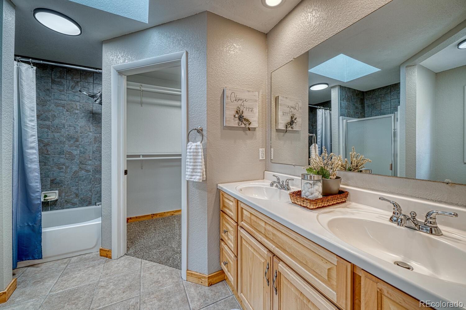 318 Southgate Road Florissant, CO 80816 - Photo 19 of 48 a bathroom with a sink double vanity and a shower