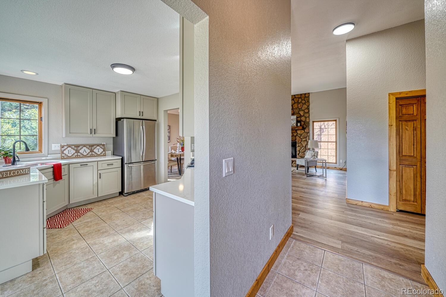 318 Southgate Road Florissant, CO 80816 - Photo 3 of 48 a kitchen with refrigerator and cabinets
