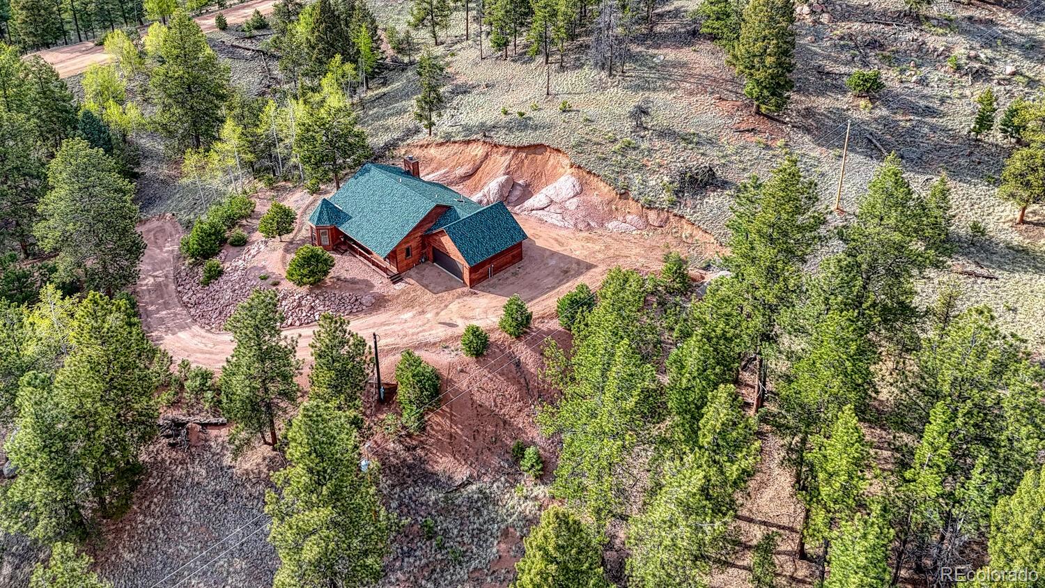 318 Southgate Road Florissant, CO 80816 - Photo 32 of 48 an aerial view of a house with a yard and trees