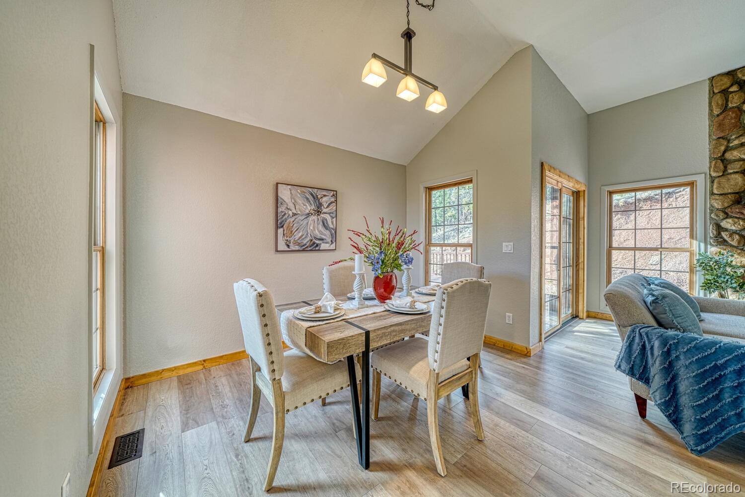 318 Southgate Road Florissant, CO 80816 - Photo 5 of 48 a view of a dining room with furniture wooden floor and a chandelier