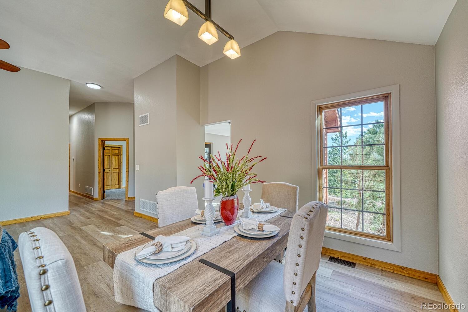 318 Southgate Road Florissant, CO 80816 - Photo 6 of 48 a view of a dining room with furniture window and wooden floor