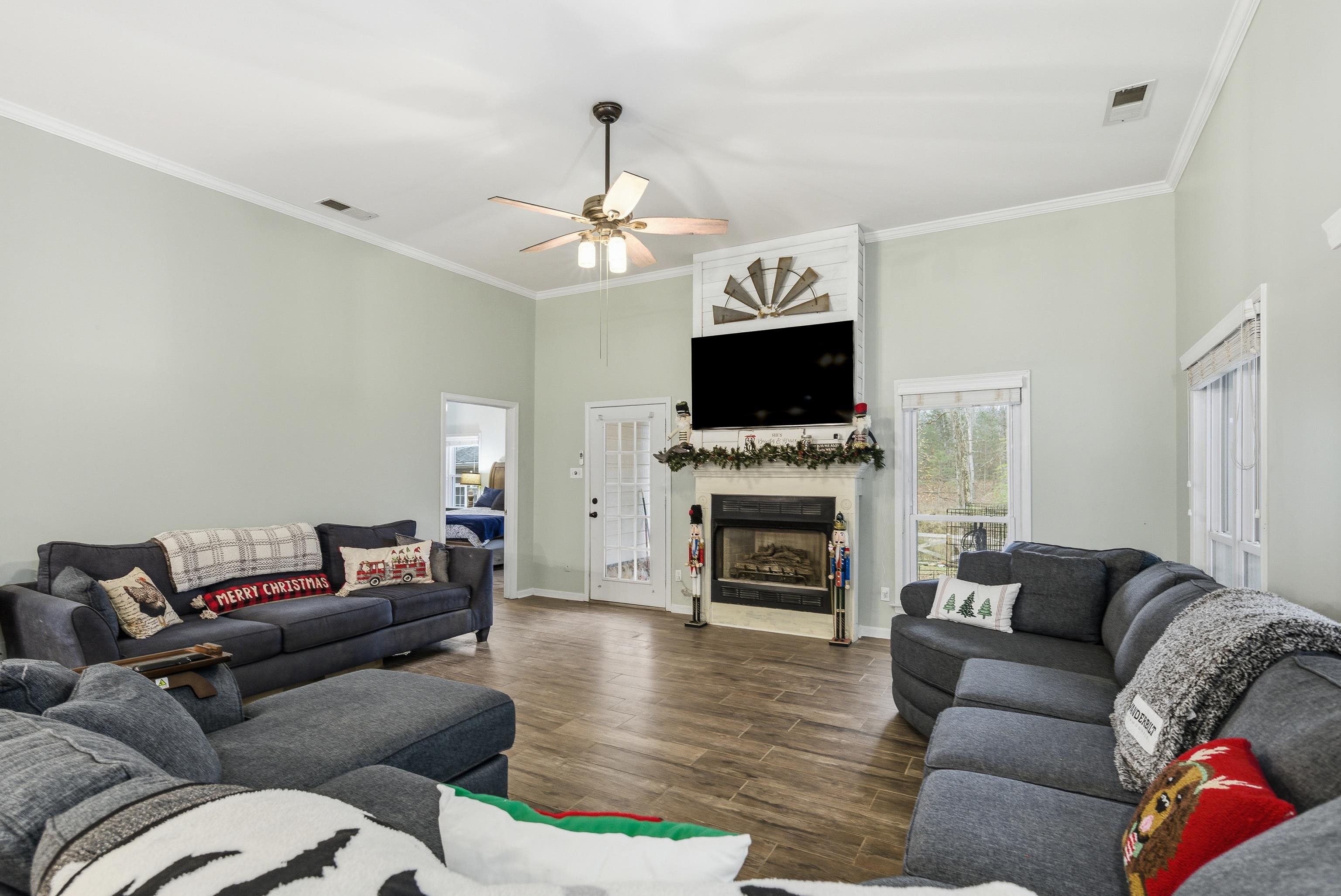 1755 Country Club Road Somerville, TN 38068 - Photo 17 of 40 a living room with furniture a fireplace and a flat screen tv