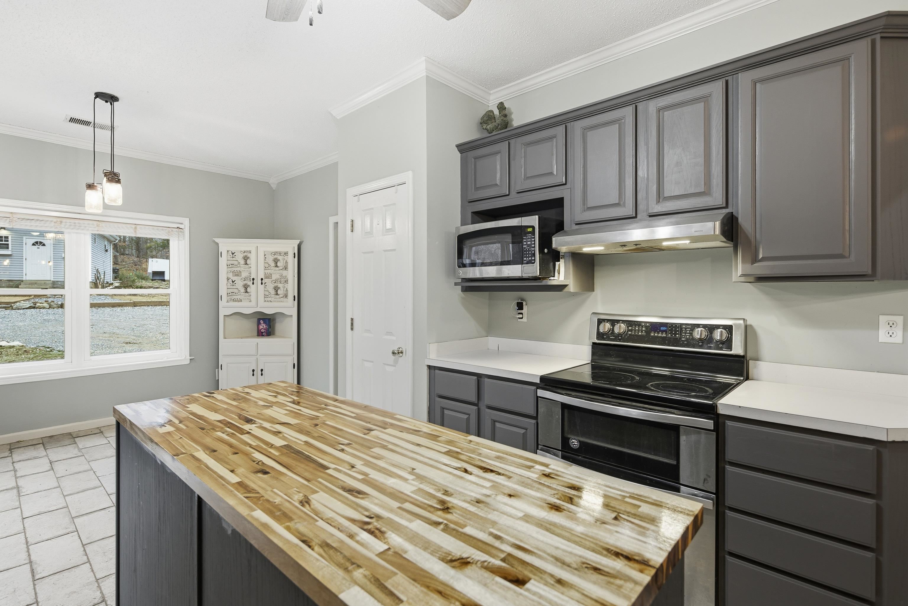1755 Country Club Road Somerville, TN 38068 - Photo 22 of 40 a kitchen with a stove and a sink