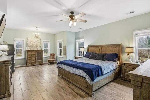 a bedroom with a bed and a television