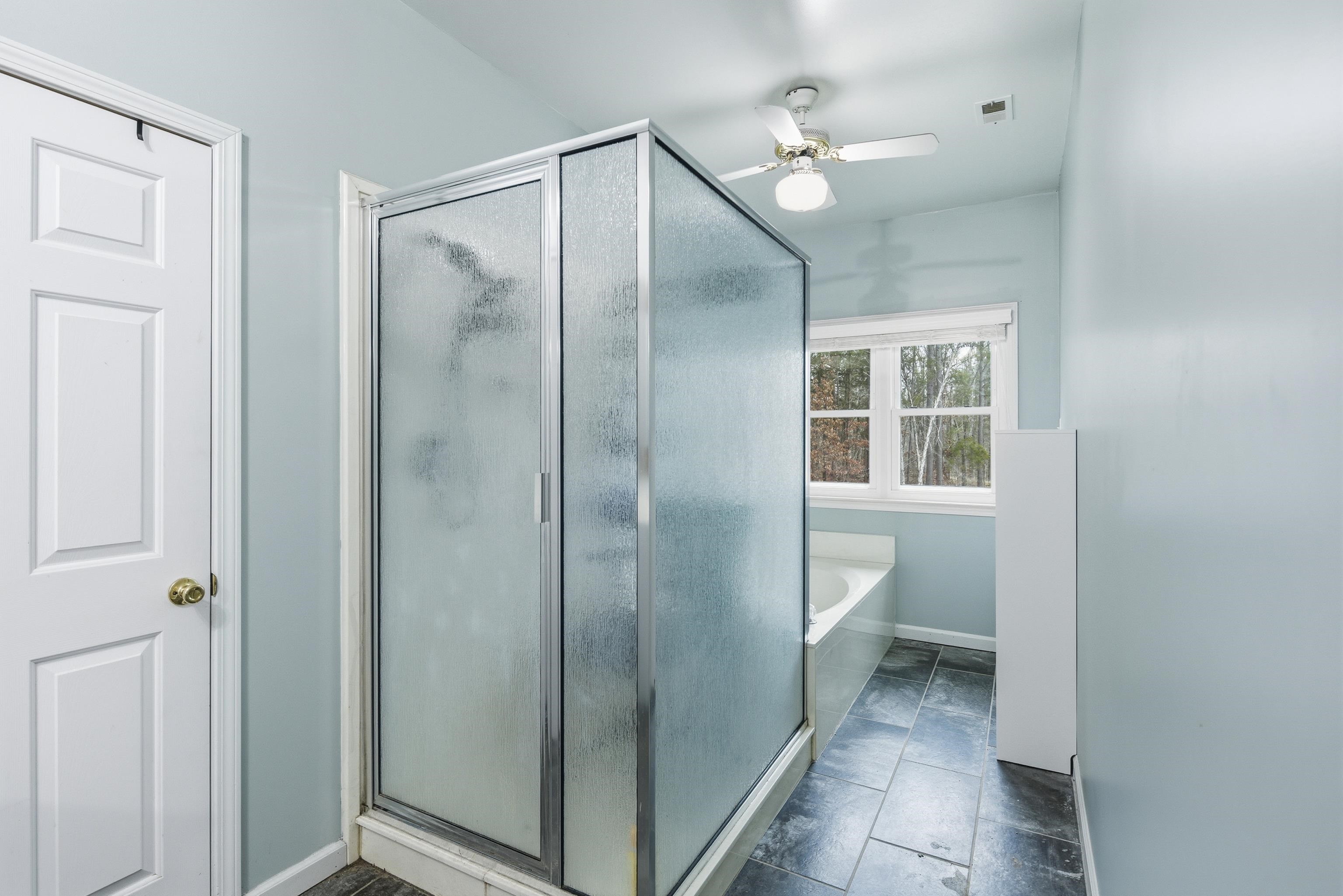 1755 Country Club Road Somerville, TN 38068 - Photo 30 of 40 a bathroom with a glass shower door and a toilet sink