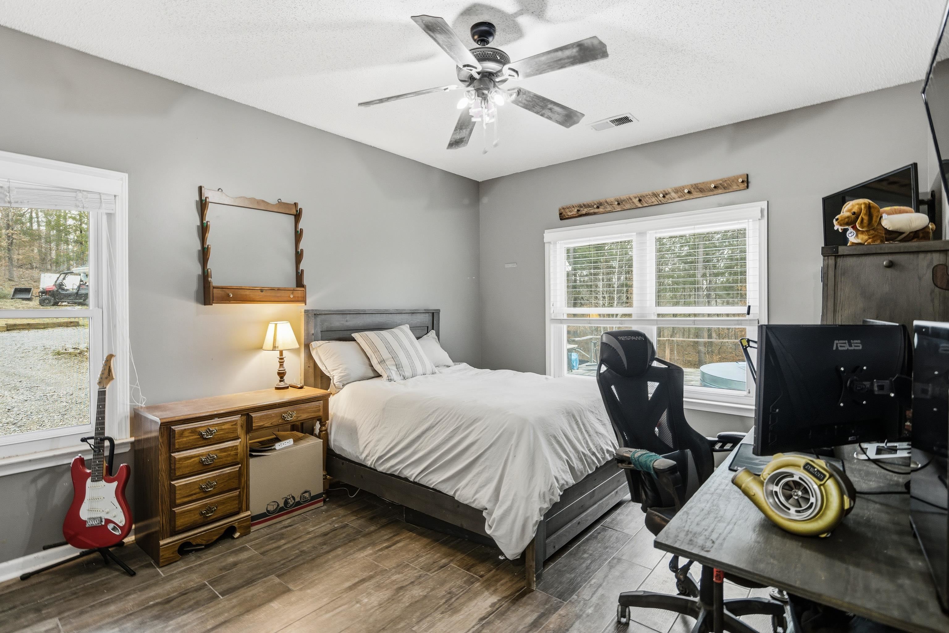 1755 Country Club Road Somerville, TN 38068 - Photo 32 of 40 a bedroom with a bed and dresser with wooden floor