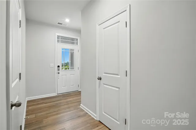 a view of a hallway with wooden floor