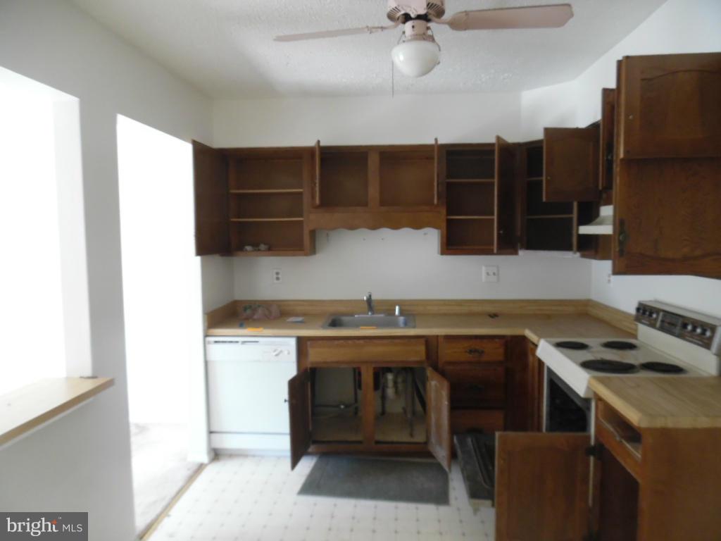 144 Farm Road Aberdeen, MD 21001 - Photo 3 of 12 a kitchen with a sink a stove and cabinets