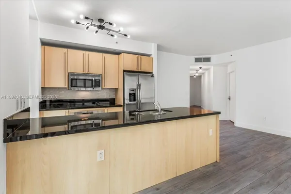 a kitchen with stainless steel appliances a sink stove and cabinets