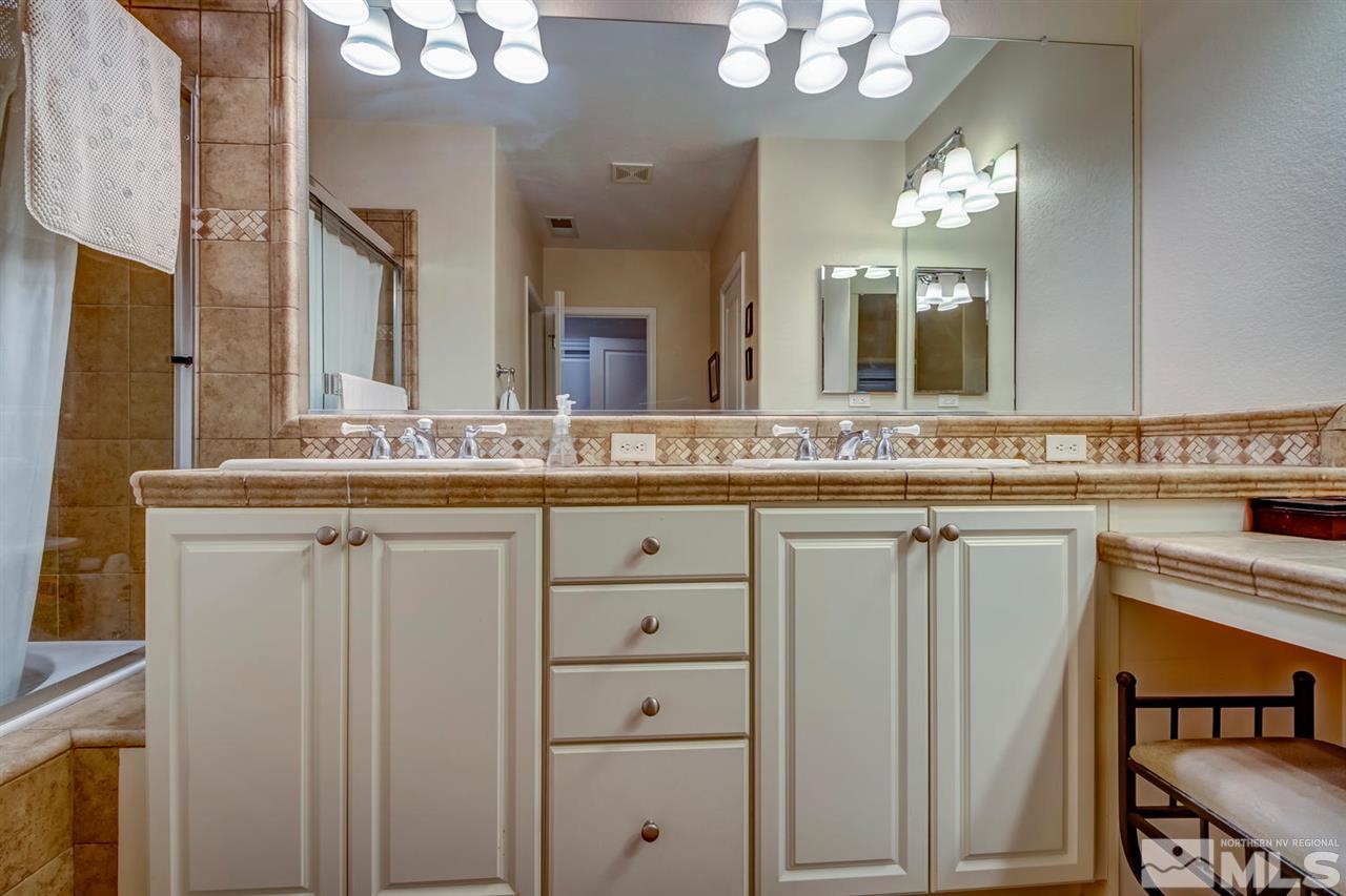 7675 Pebblestone Way Reno, NV 89523 - Photo 14 of 25 a bathroom with a granite countertop sink and a mirror