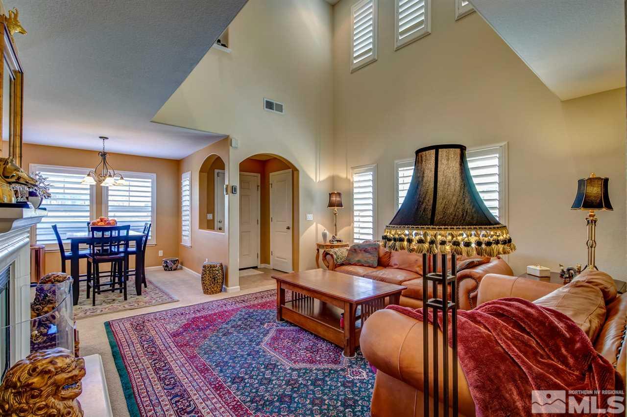 7675 Pebblestone Way Reno, NV 89523 - Photo 3 of 25 a living room with furniture a rug and a table