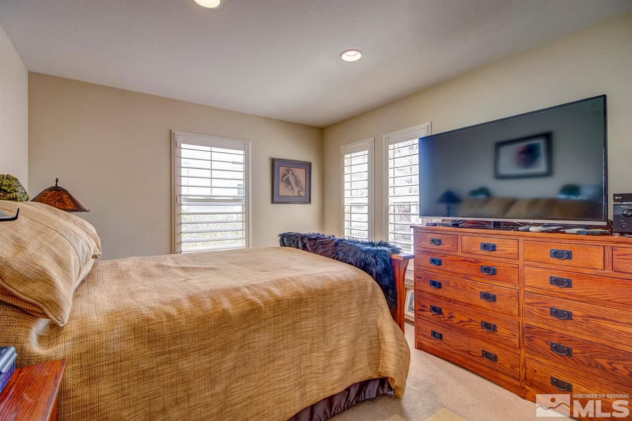 7675 Pebblestone Way Reno, NV 89523 - Photo 10 of 25 a bedroom with a bed and a flat screen tv