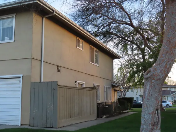 a side view of a house with a yard
