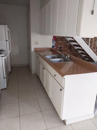 a kitchen with a sink stove and cabinets