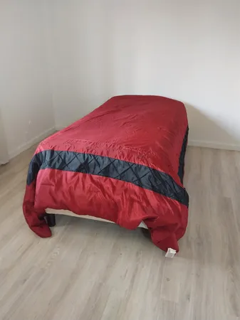 a bedroom with a bed and a chair