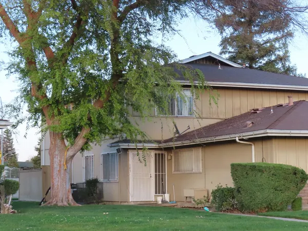 a house that has tree in front of it