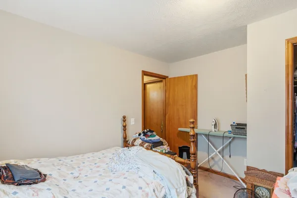 a bed room with a bed and a chair