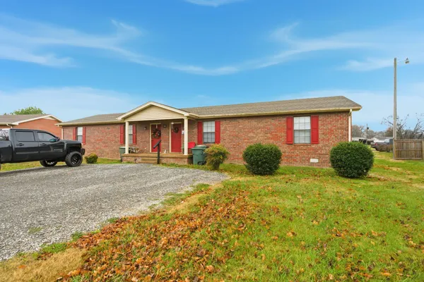a front door view of a house with a yard
