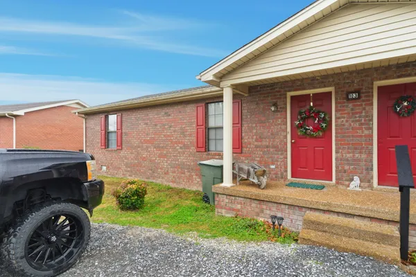 a front view of a house with garden and porch