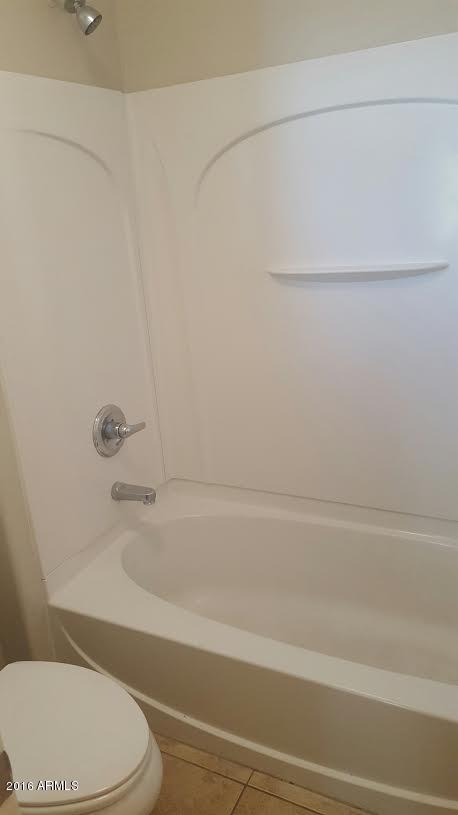 14039 West Country Gables Drive Surprise, AZ 85379 - Photo 21 of 32 a bathroom with a toilet and a bathtub