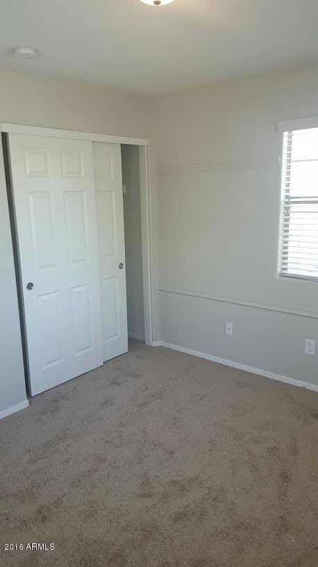 14039 West Country Gables Drive Surprise, AZ 85379 - Photo 24 of 32 an empty room with windows
