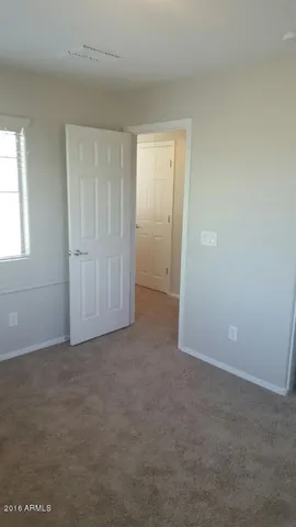 a view of a livingroom with an empty space and a window