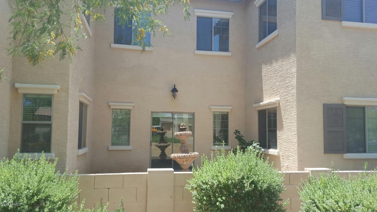 14039 West Country Gables Drive Surprise, AZ 85379 - Photo 29 of 32 a front view of a house with garden