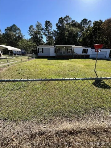 a view of a swimming pool with a yard