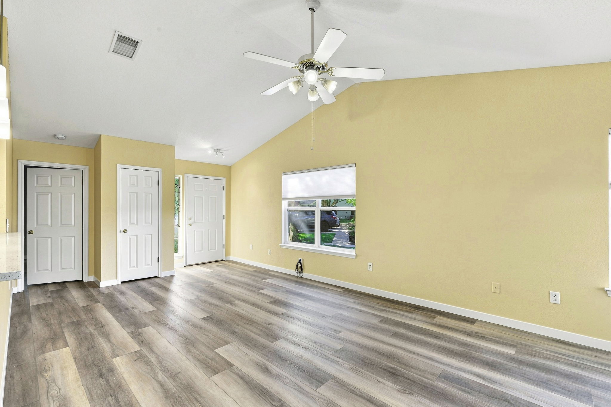 196 Prairie Springs Loop Georgetown, TX 78626 - Photo 8 of 34 Slanted ceilings and gorgeous wood look vinyl plank flooring define this versatile open living space.