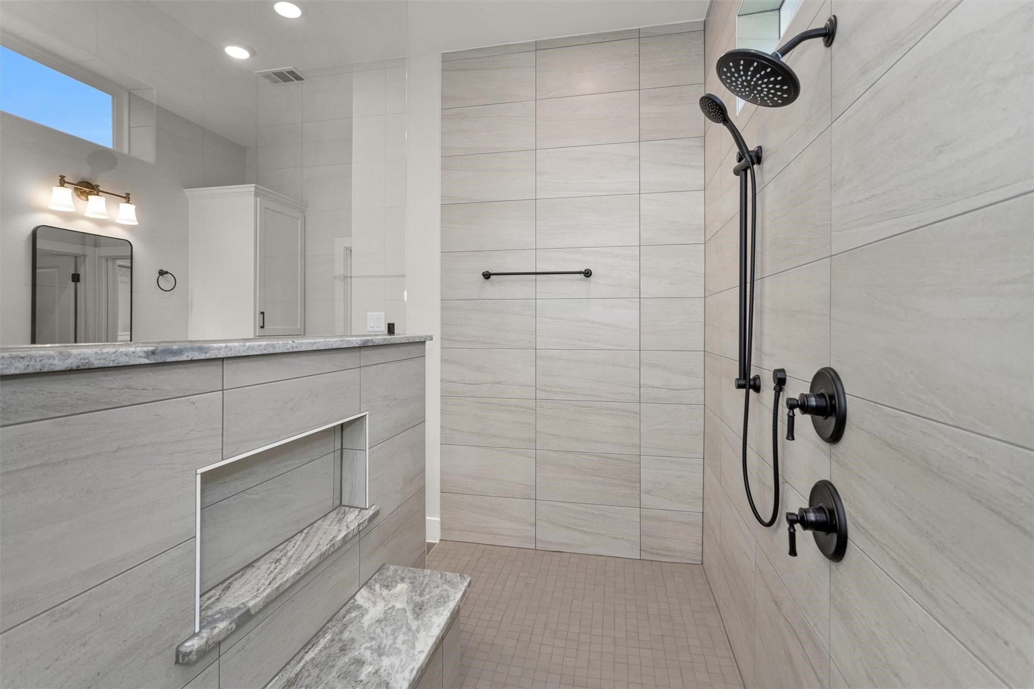 12744 Oak Barrel Road Willis, TX 77378 - Photo 21 of 38 Enjoy plenty of elbow room in this expansive walk-in shower, thoughtfully designed to provide both comfort and luxury. With generous space to move freely, the layout enhances the spa-like feel while maintaining a sleek, modern look. This oversized shower offers the perfect blend of functionality and relaxation for your daily routine.