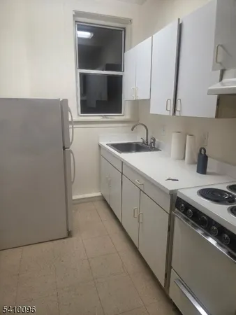 a kitchen with a sink and a stove top oven