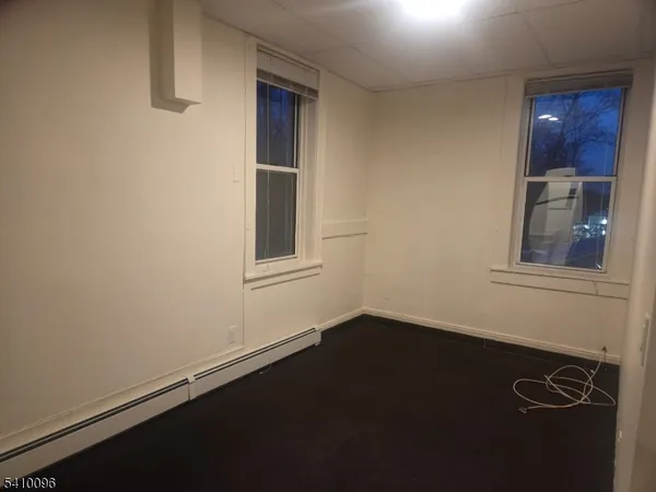 a view of a livingroom with an empty space and a window