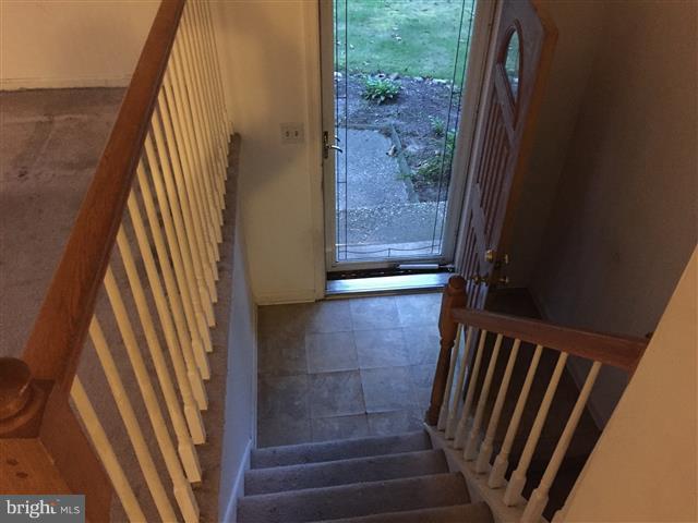 166 Dundee Road Severna Park, MD 21146 - Photo 12 of 25 a view of a hallway with wooden floor and a bathroom