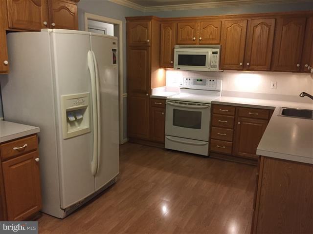 166 Dundee Road Severna Park, MD 21146 - Photo 7 of 25 a kitchen with a refrigerator sink and cabinets