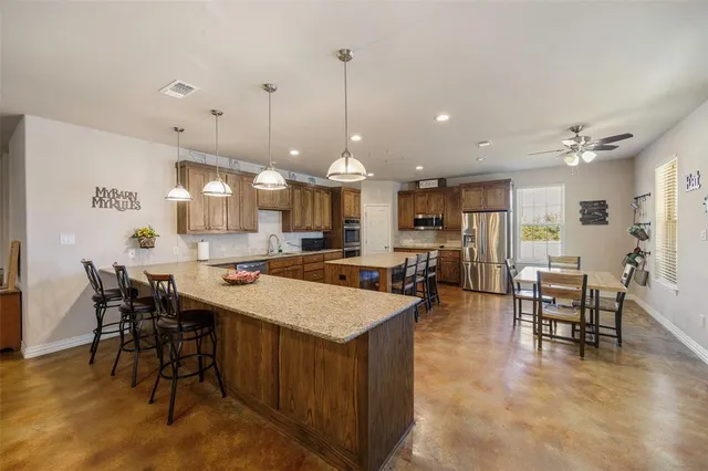 a large kitchen with a table and chairs