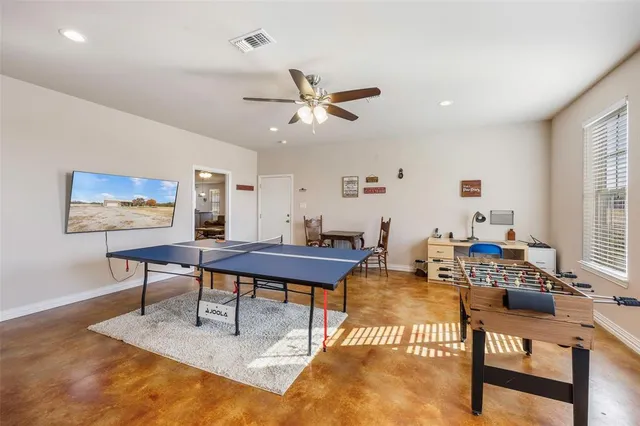 a living room with furniture a rug and a window